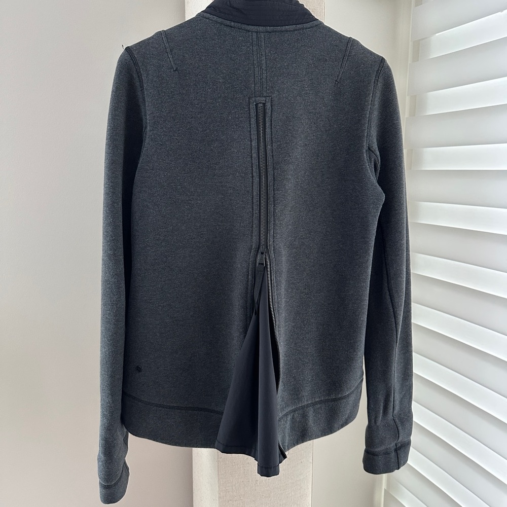 Lululemon classic and rare jacket with beautiful back zipper ruffle - size 10.